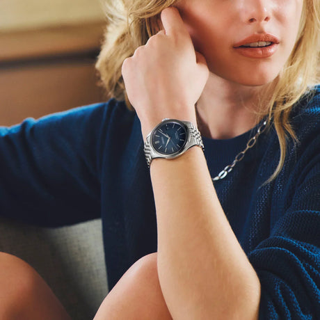 beautiful women wearing a seiko Pressage while sitting down and raising her arm